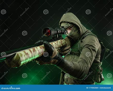 An Athletic Guy with a Tattoo Poses with a Sniper Rifle Stock Photo - Image of ammo, criminal ...