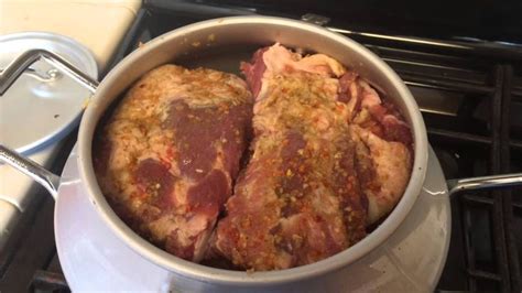 two pieces of meat in a pot on the stove