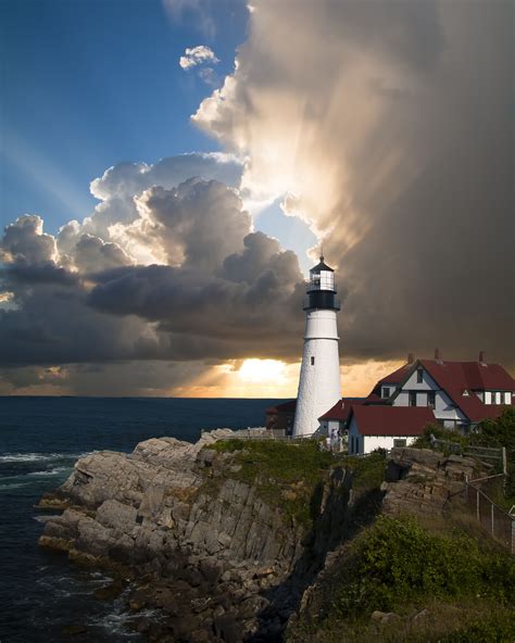 White and Black Lighthouse Near the Cliff and White and Red House · Free Stock Photo