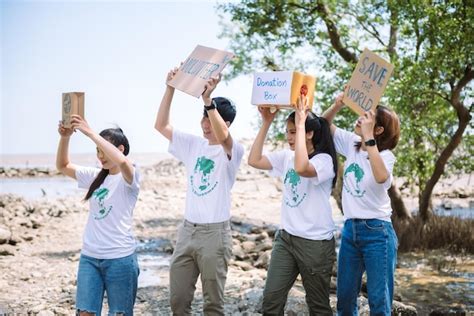 Premium Photo | Group of volunteers hold a volunteer sign in world ...