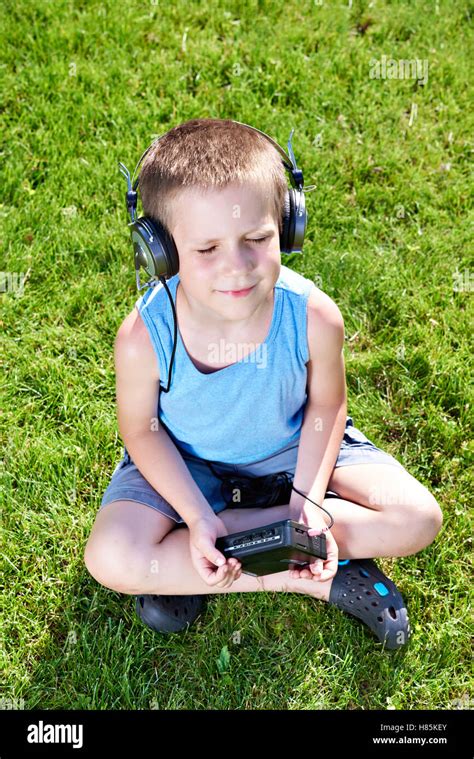 Little boy with old audio cassette player and headphones Stock Photo - Alamy