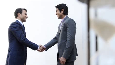 Shot Of Two Businessmen Shaking Their Hands And Talking Stock Footage ...