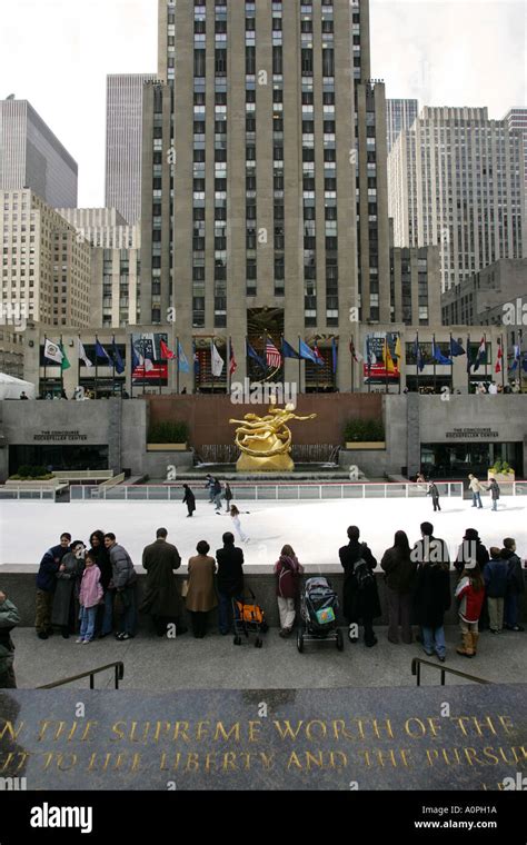 Tourists watch the winter ice skating at the famous New York City landmark Rockefeller center ...