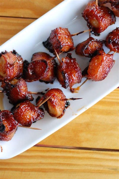 bacon wrapped in toothpicks on a white plate