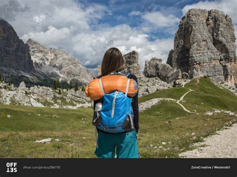 Italy- Woman trekking in the Dolomites stock photo - OFFSET