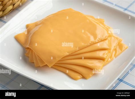 Slices of cheddar cheese ready to melt close up Stock Photo - Alamy