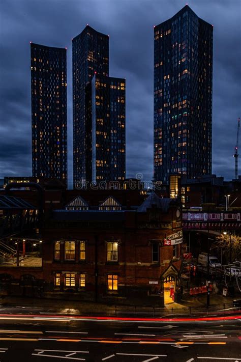 Vertical Night View of Deansgate Square with Four Skyscraper Towers Under the Cloudy Sky ...