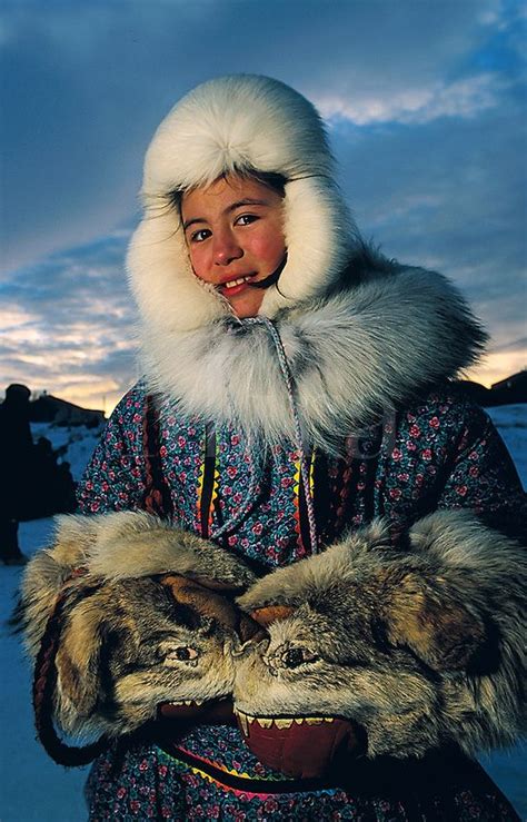 Portrait of a Native Alaskan woman wearing a fur hat and traditional ...