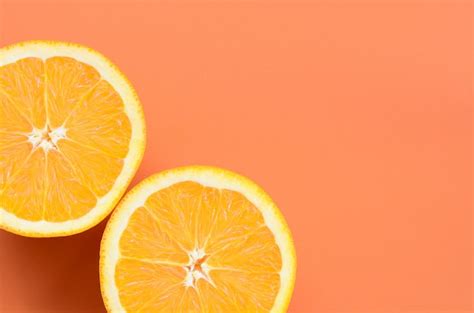 Premium Photo | Top view of a several orange fruit slices on bright background in orange color