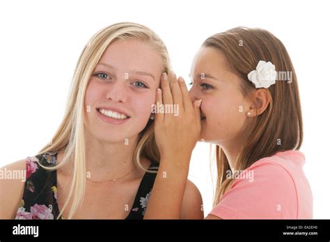 Teen girls are whispering funny gossip to each other Stock Photo - Alamy