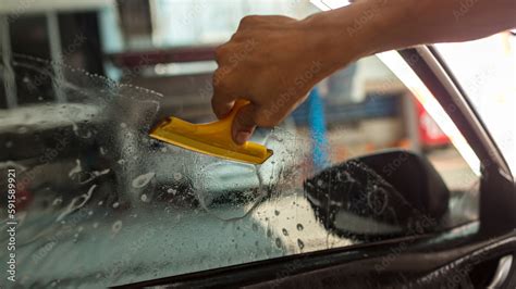 Technician Installing car window tint. Car window tinting series. Car ...