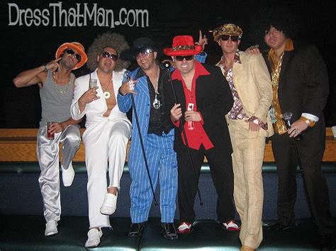 a group of men dressed in costumes posing for a photo with one man ...