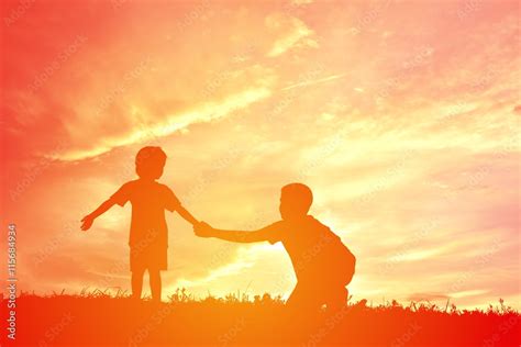 Silhouette children playing on sunset Stock Photo | Adobe Stock