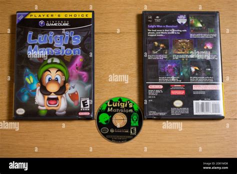 A Disc and Case for Luigi's Mansion for the Nintendo Gamecube on a wood floor Stock Photo - Alamy