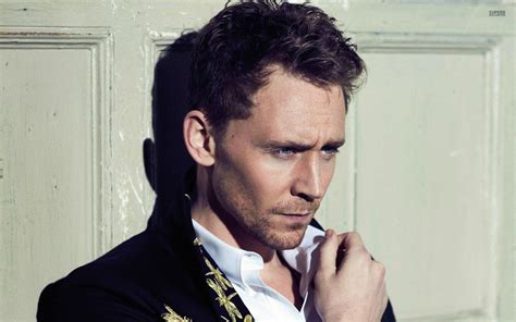 Tom Hiddleston in front of a wooden door wallpaper - Male