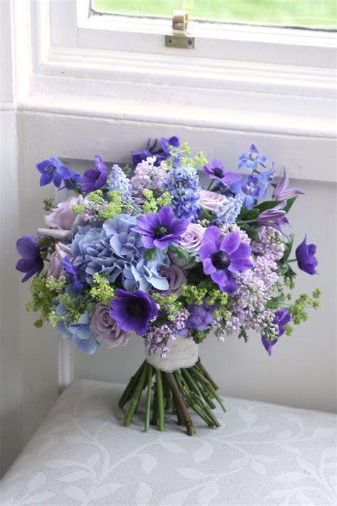 Wedding bouquet in blue, purple and green with anemone, roses ...