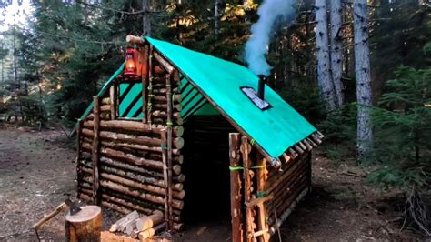 Building complete and warm survival shelter / Log Cabin Building in the ...