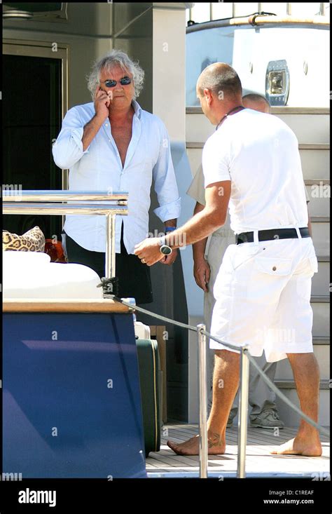 Flavio Briatore talking on his mobile phone before departing from a ...