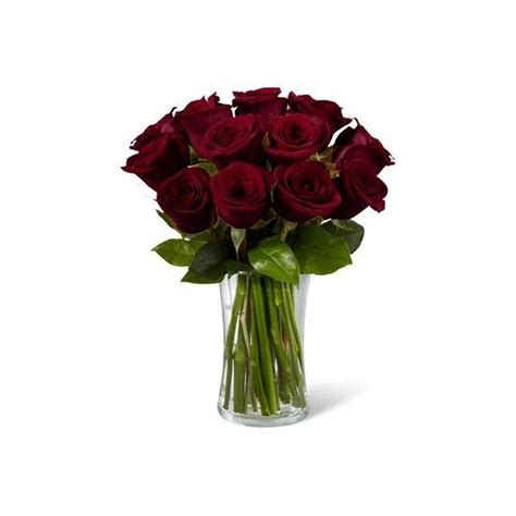 a vase filled with lots of red roses