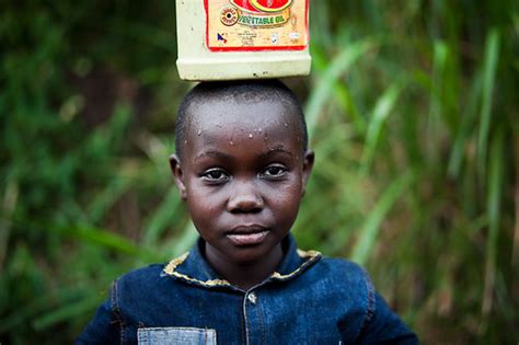 Lendu girl carrying vegetable cooking oil - DR CONGO - | Flickr