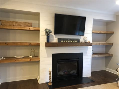 Shiplap wall with floating shelves and new mantle around fireplace ...