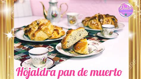 there are two pastries on the table with cups and saucers next to each other