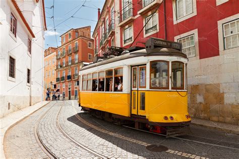 Tram on narrow street of alfama lisbon featuring lisbon, portugal, and ...