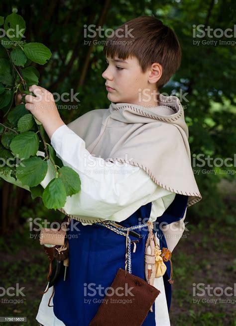 Boy In Mediaeval Clothing At A Hazelnut Tree Stock Photo - Download Image Now - 12-13 Years ...