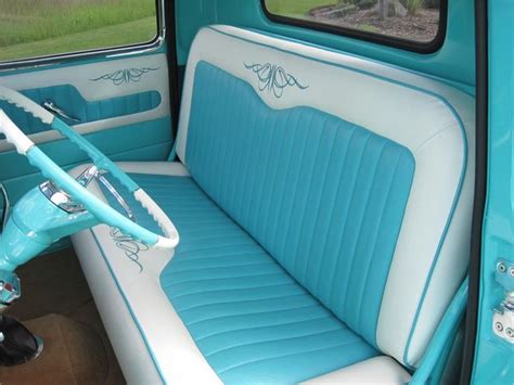 the interior of an old car with blue and white leather