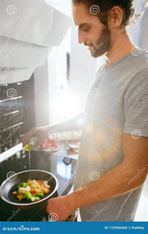 Handsome Man Cooking Breakfast at Home in Kitchen. Stock Photo - Image ...