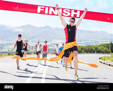 Runner crossing race finish line Stock Photo - Alamy