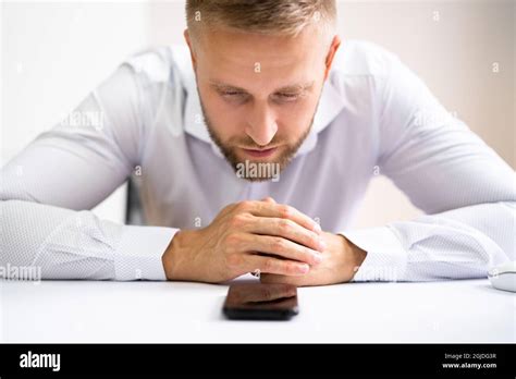 Man Waiting Phone Call At Office Desk Stock Photo - Alamy