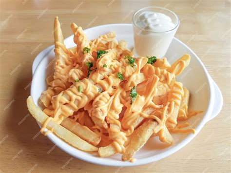 Premium Photo | French fries with cheddar cheese and sauce