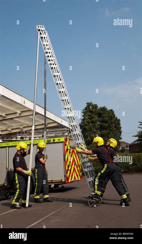 Dorset Fire and Rescue Service fireman preparing the ladder at Stock ...