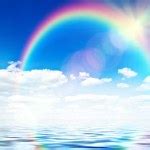 Blue sky background with rainbow and reflection in water — Stock Photo © robertsrob #14403255