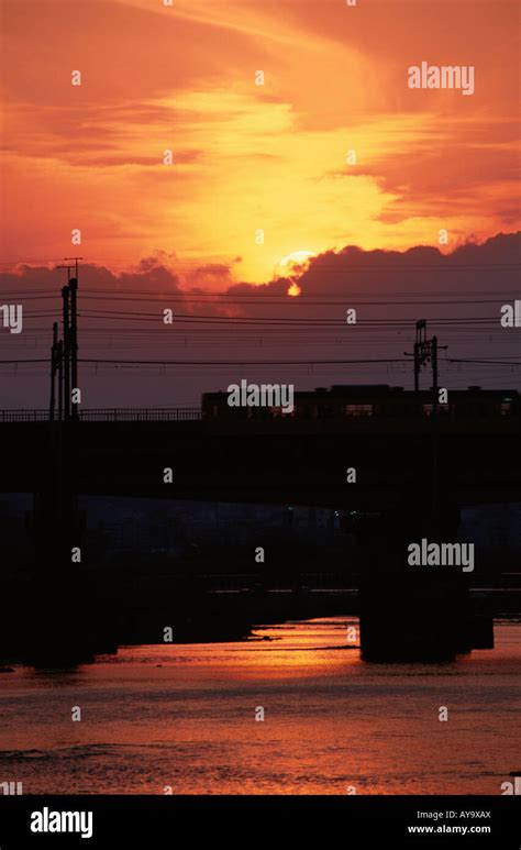 Train on Bridge in Sunset Stock Photo - Alamy