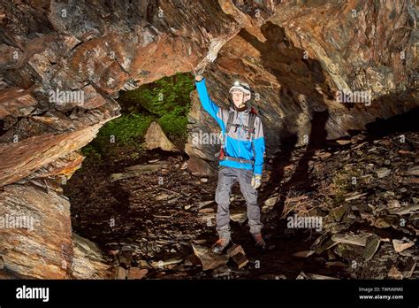 Young speleologist exploring a cave Stock Photo - Alamy