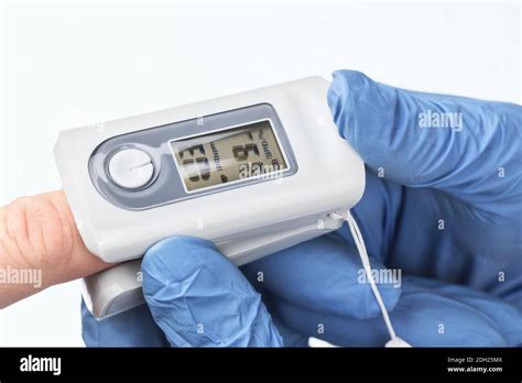 Doctor using pulse oximetry to check coronavirus COVID-19 symptoms at ...