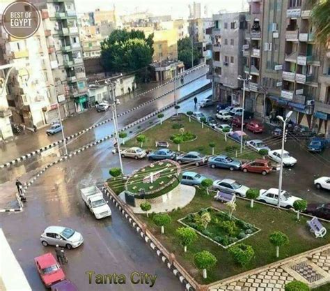 an aerial view of a city street with cars parked in it