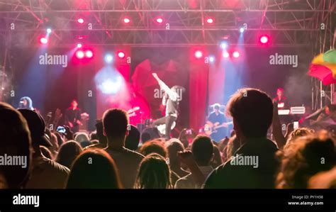 Cheering concert audience looking at vocalist on stage Stock Photo - Alamy