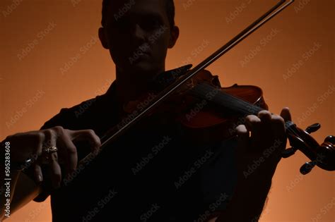 Violin soloist playing his violin Stock Photo | Adobe Stock