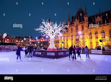 Christmas Ice skating rink in the Bruges Market Square Stock Photo - Alamy