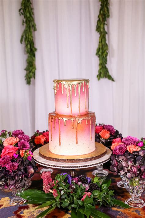 Two Tier Round Pink and White Ombre Wedding Cake with Gold Drip Frosting on Gold Cake Stand with ...
