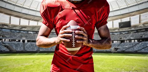 Premium Photo | American football player against rugby goal post on a ...