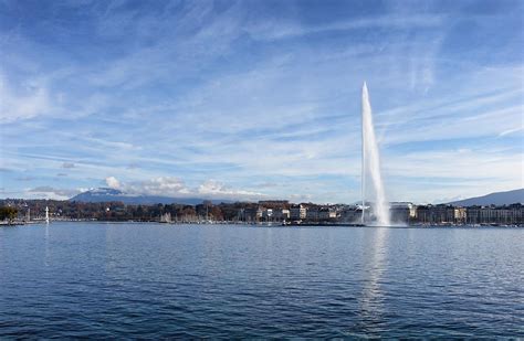 Lake Geneva Switzerland With Water Fountain And Blue Sky With Cl ...