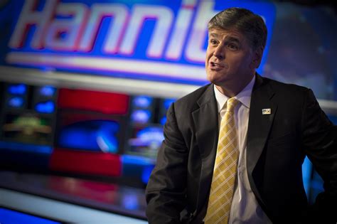 Fox News Channel anchor Sean Hannity poses for photographs as he sits on the set of his show ...