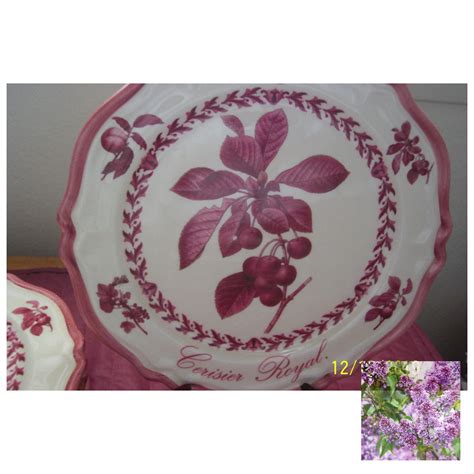 two plates with purple flowers on them next to each other