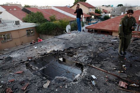 19 Israelis inspect the damage to a house that was hit by a rocket fired by Palestinian ...