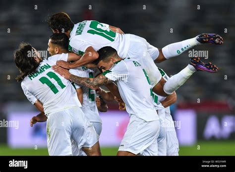 Players of Iraq national football team celebrate after scoring against Vietnam national football ...