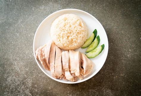 Premium Photo | Hainanese chicken rice or rice steamed with chicken soup